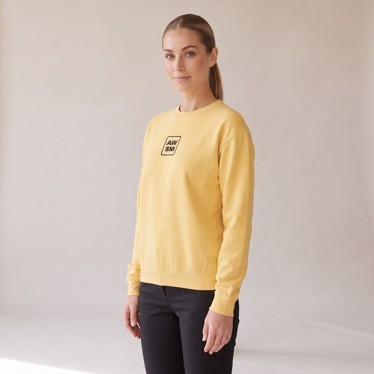Brioche Crewneck — AWSM Atelier in Butter Cream, three-quarter view on the AWSM house model