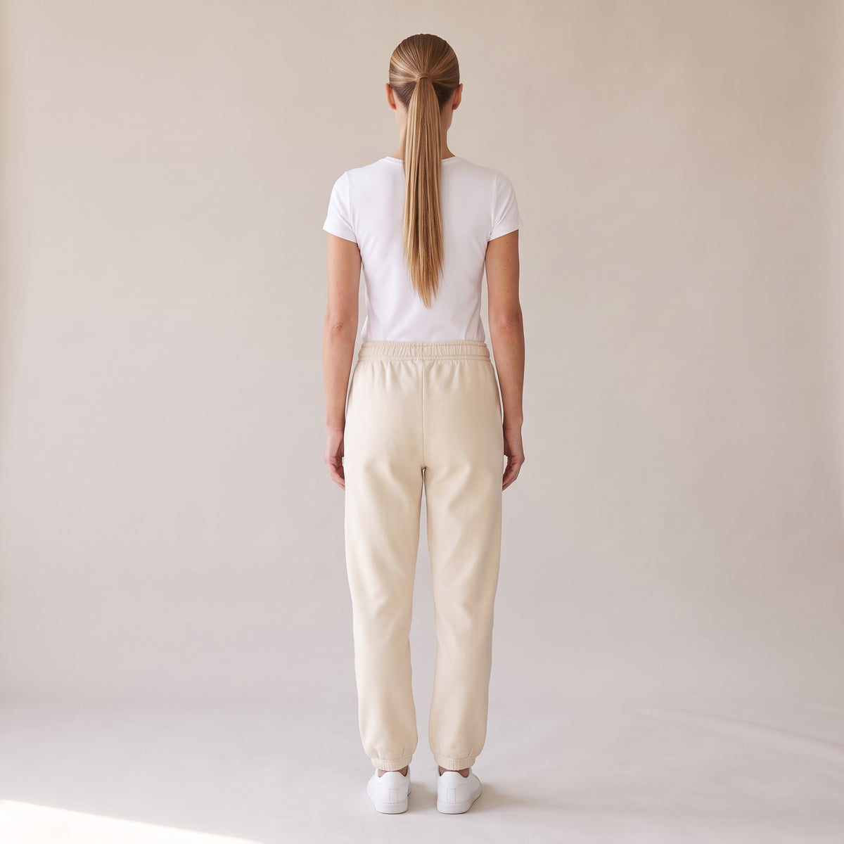 Cabernet Heavyweight Sweatpants — AWSM Atelier in Stone Dust, back view on the AWSM house model