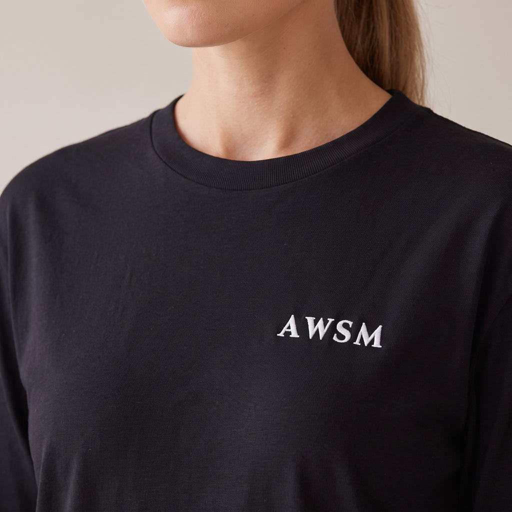 Crépuscule Long Sleeve Tee — AWSM Maison in Onyx Black, close-up of the embroidery on the AWSM house model