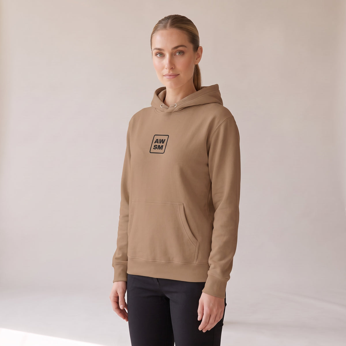 Galerie Hoodie — AWSM Atelier in Café Latte, three-quarter view on the AWSM house model