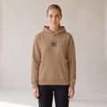 Galerie Hoodie — AWSM Atelier in Café Latte, shown on the AWSM house model