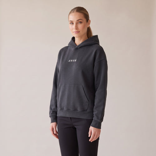 Héritage Vintage Hoodie — AWSM Maison in Volcanic Black, three-quarter view on the AWSM house model