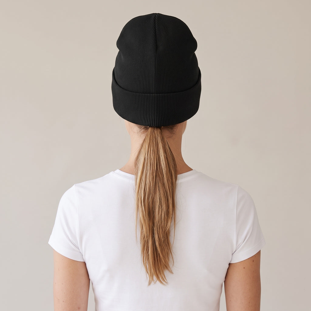 Hiver Cuffed Beanie — AWSM Maison in Onyx Black, back view on the AWSM house model
