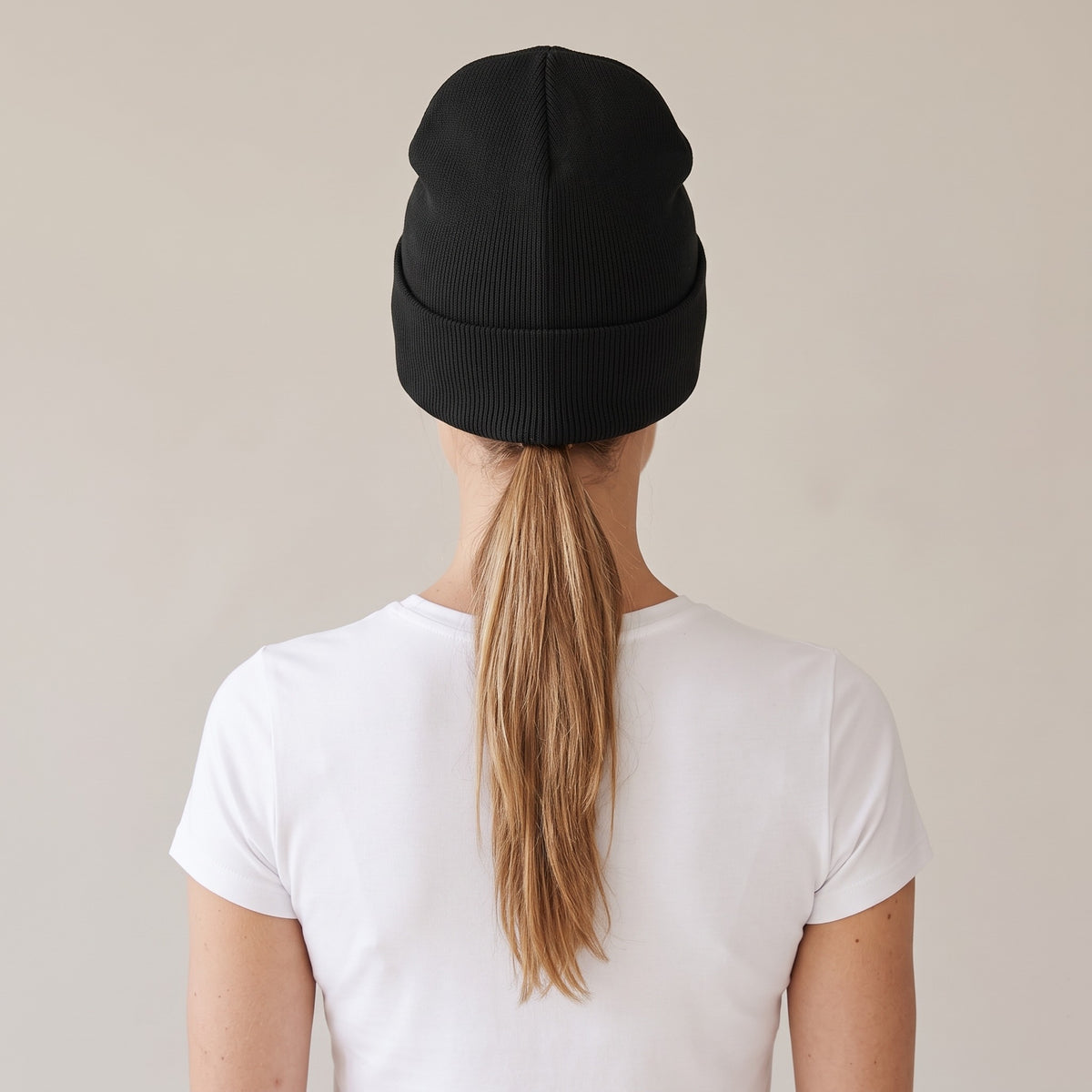 Hiver Cuffed Beanie — AWSM Maison in Onyx Black, back view on the AWSM house model