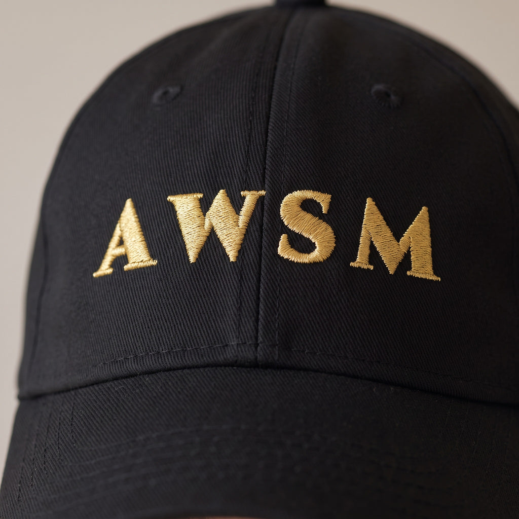Laurel Dad Hat — AWSM Aurum in Onyx Black, close-up of the embroidery on the AWSM house model