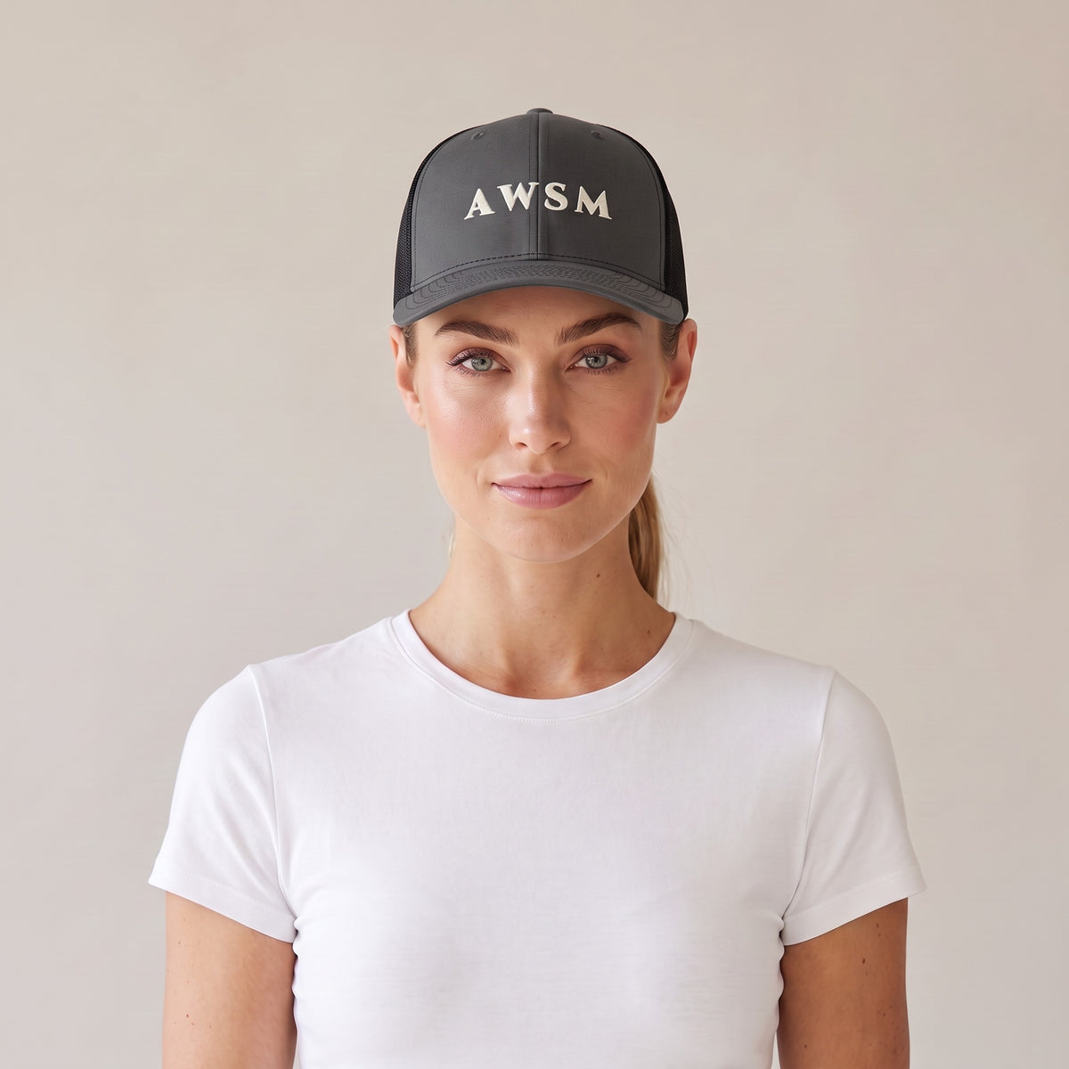 Minuit Trucker Cap — AWSM Maison in Graphite / Onyx, front view on the AWSM house model