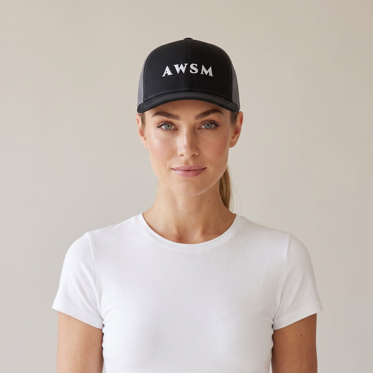 Minuit Trucker Cap — AWSM Maison in Onyx / Graphite, shown on the AWSM house model