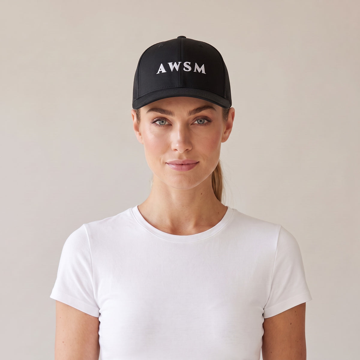Minuit Trucker Cap — AWSM Maison in Onyx Black, front view on the AWSM house model