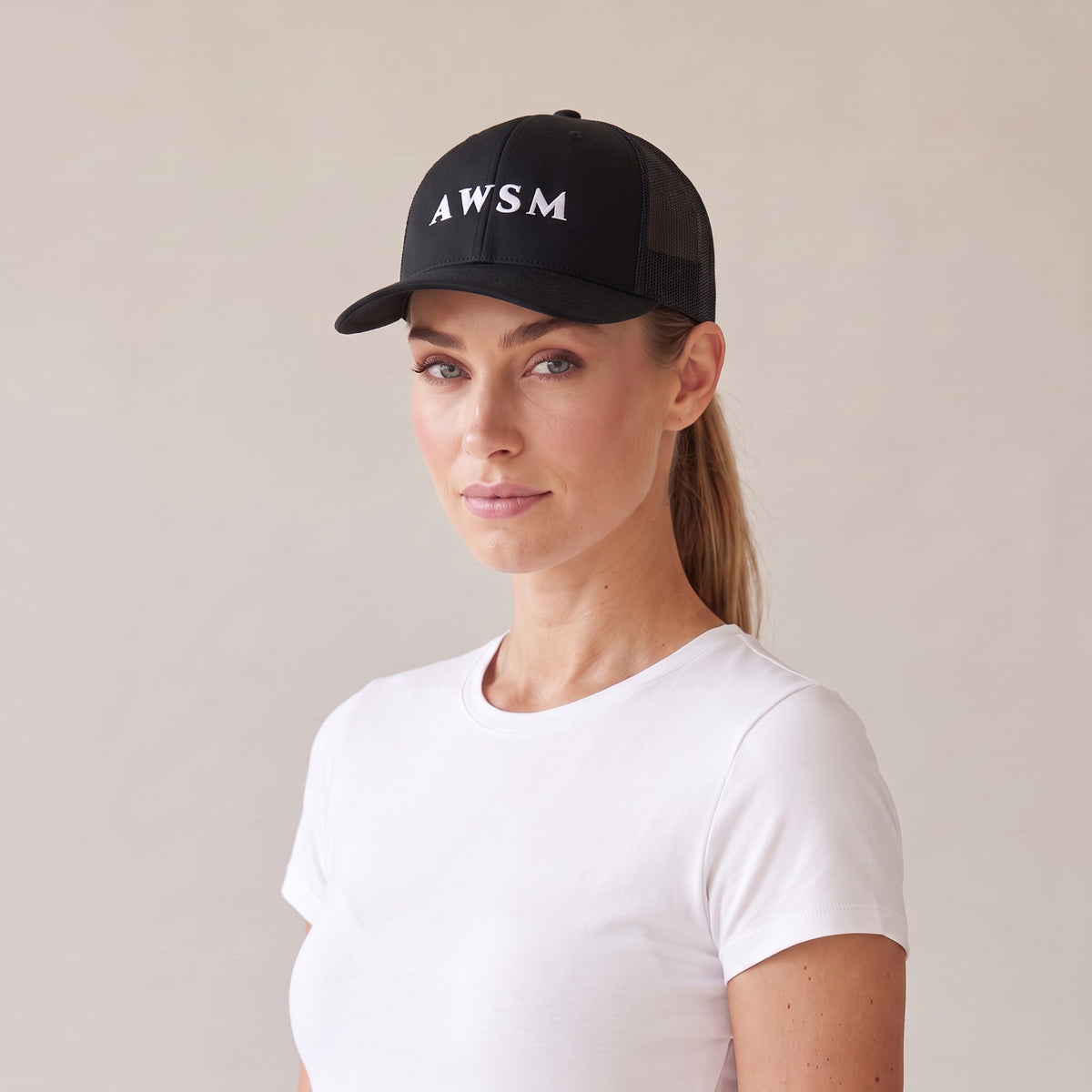 Minuit Trucker Cap — AWSM Maison in Onyx Black, three-quarter view on the AWSM house model