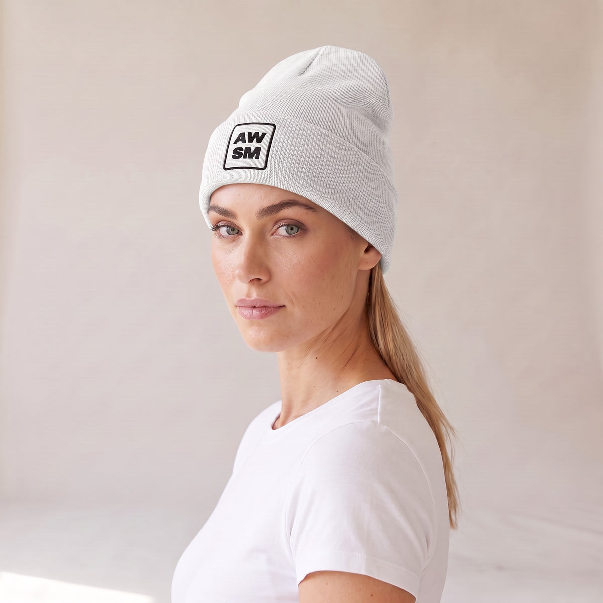 Neige Cuffed Beanie — AWSM Atelier in Pearl White, three-quarter view on the AWSM house model