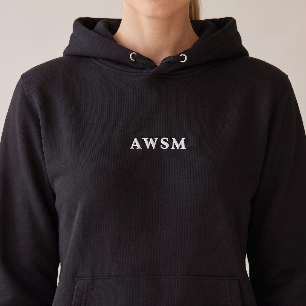 Opéra Hoodie — AWSM Maison in Onyx Black, close-up of the embroidery on the AWSM house model