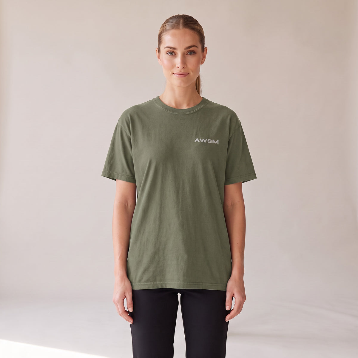 Outpost Heavyweight Tee — AWSM Field in Moss Green, front view on the AWSM house model