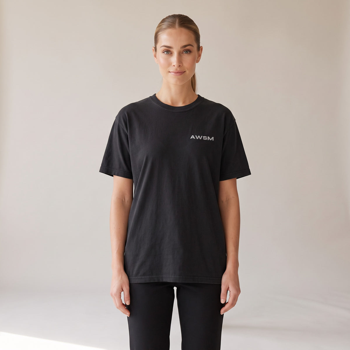 Outpost Heavyweight Tee — AWSM Field in Onyx Black, shown on the AWSM house model