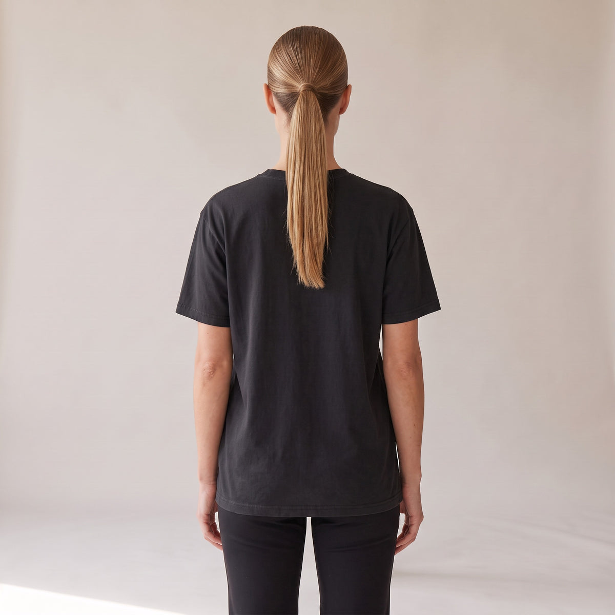 Outpost Heavyweight Tee — AWSM Field in Onyx Black, back view on the AWSM house model