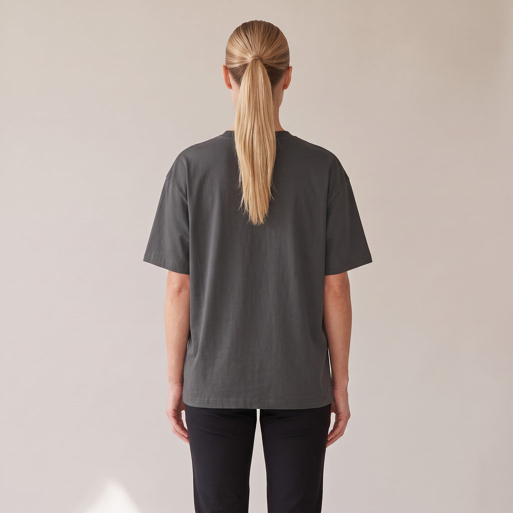 Patina Oversized Tee — AWSM Maison in Faded Onyx, back view on the AWSM house model