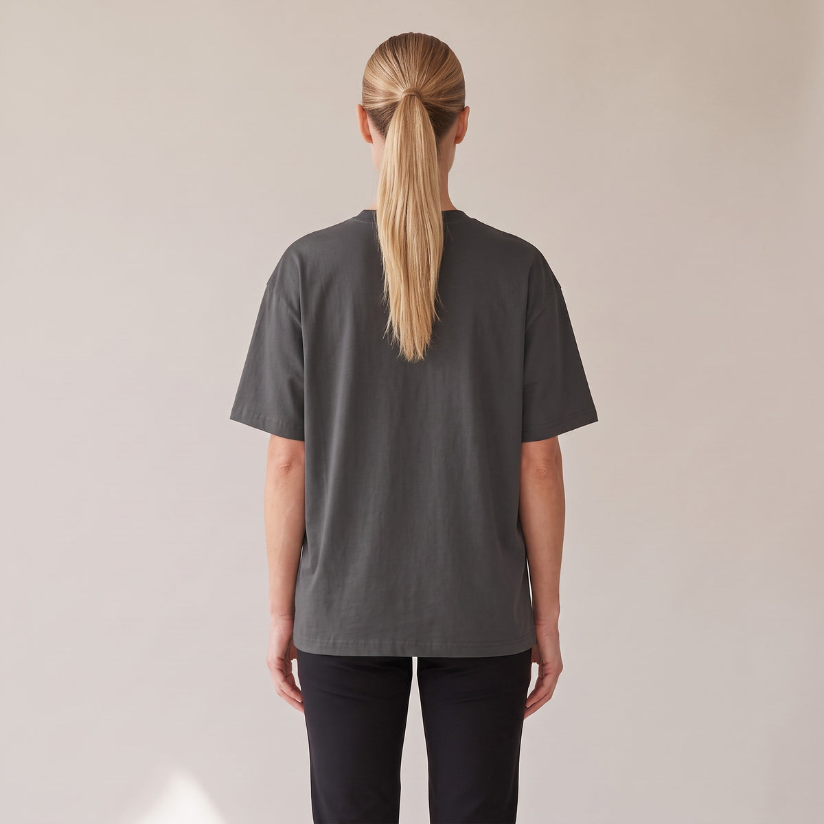 Patina Oversized Tee — AWSM Maison in Faded Onyx, back view on the AWSM house model