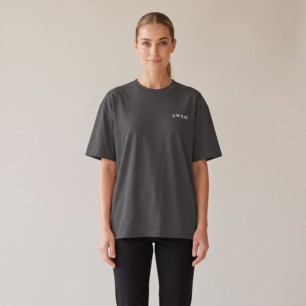 Patina Oversized Tee — AWSM Maison in Faded Onyx, shown on the AWSM house model