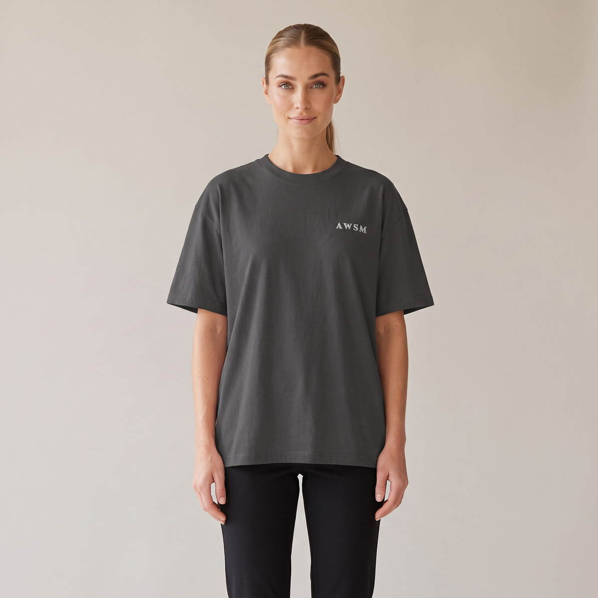 Patina Oversized Tee — AWSM Maison in Faded Onyx, shown on the AWSM house model