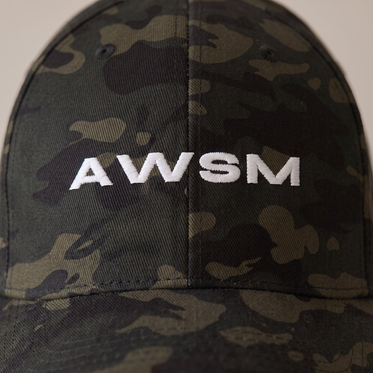 Recon Structured Cap — AWSM Field in Multicam Black, close-up of the embroidery on the AWSM house model