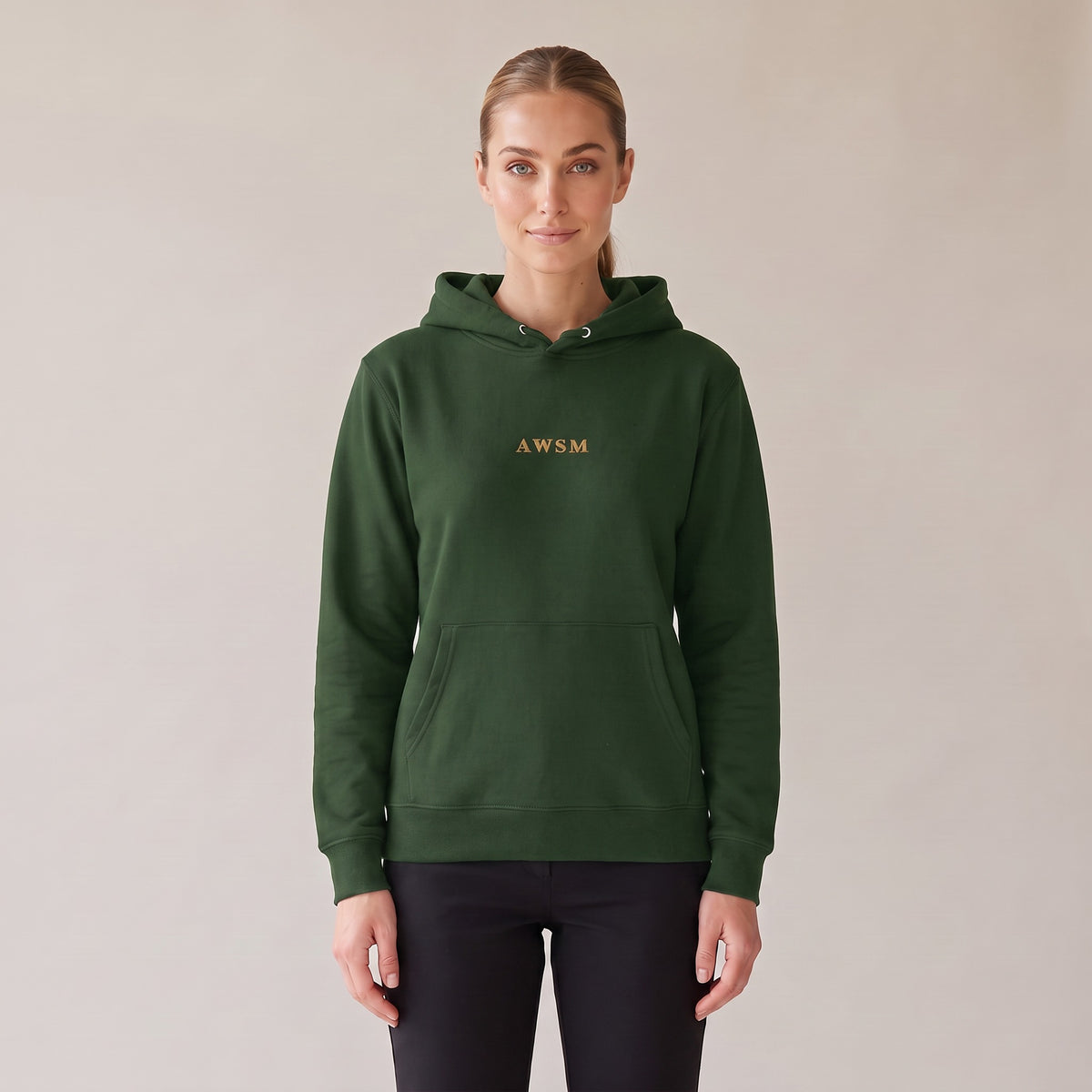 Regalia Hoodie — AWSM Aurum in Black Forest Green, front view on the AWSM house model