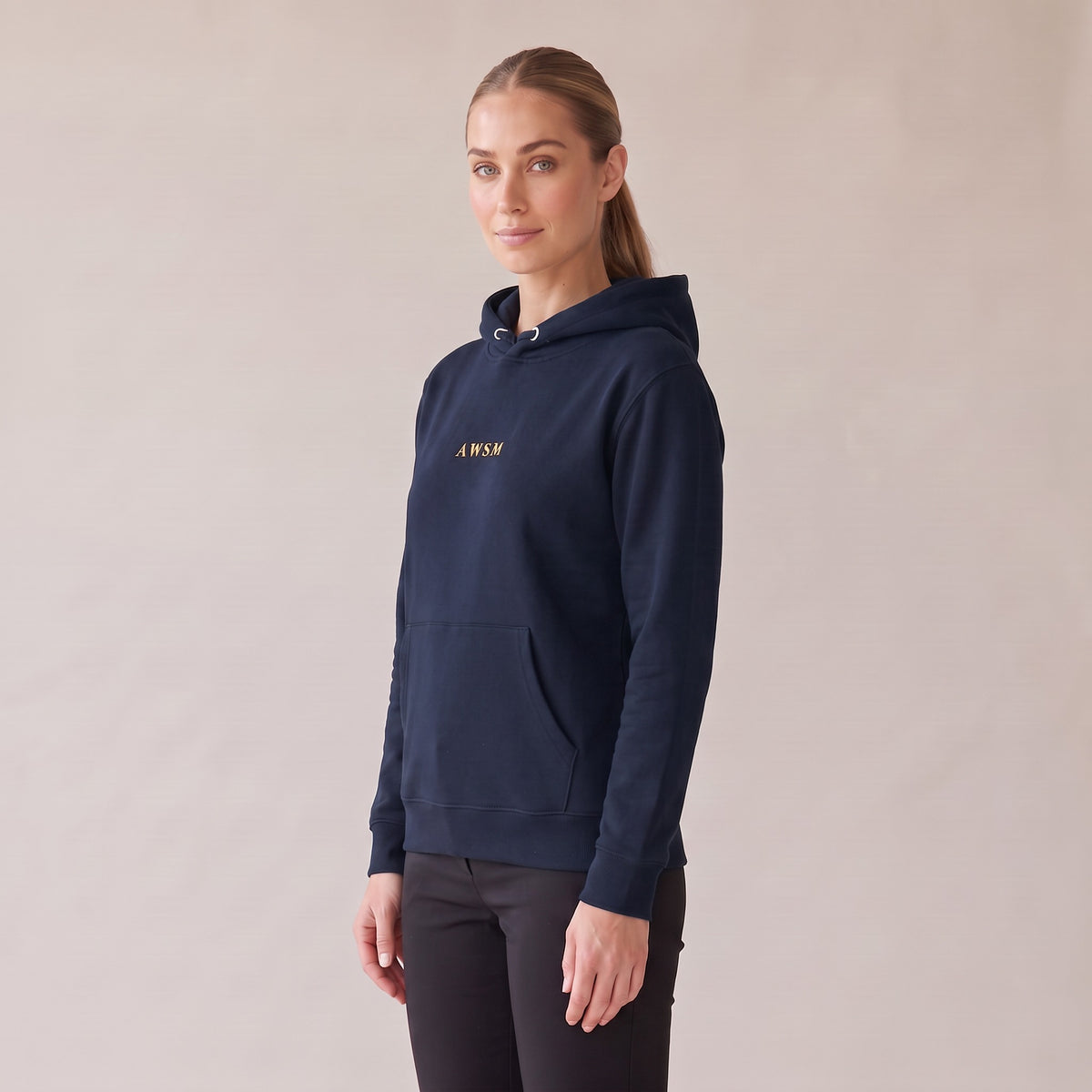 Regalia Hoodie — AWSM Aurum in Midnight Navy, three-quarter view on the AWSM house model