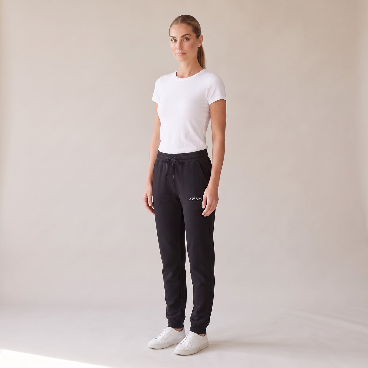 Repos Fleece Sweatpants — AWSM Maison in Onyx Black, three-quarter view on the AWSM house model