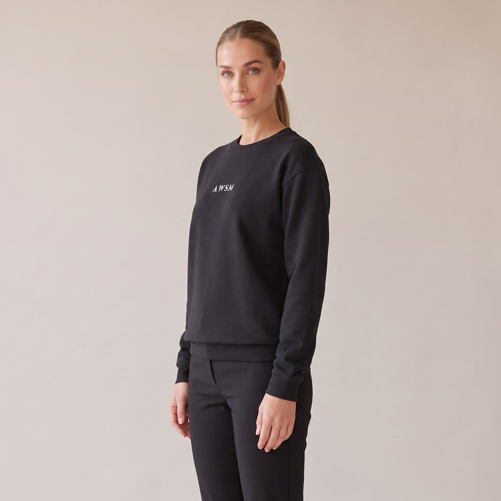 Salon Crewneck — AWSM Maison in Onyx Black, three-quarter view on the AWSM house model