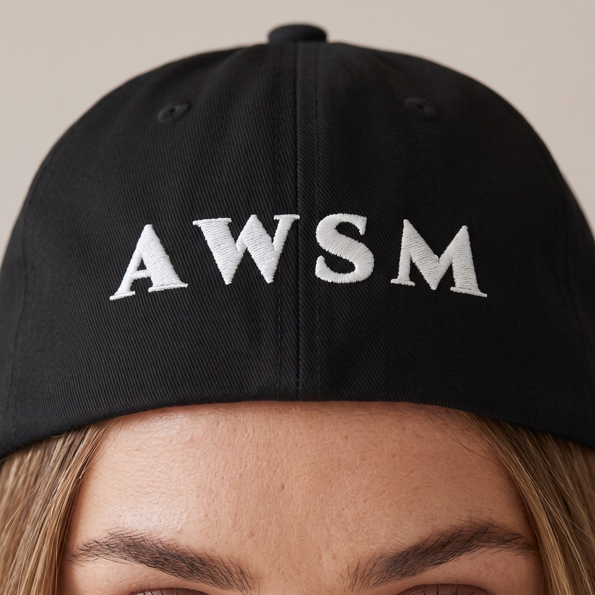 Soirée Dad Hat — AWSM Maison in Onyx Black, close-up of the embroidery on the AWSM house model