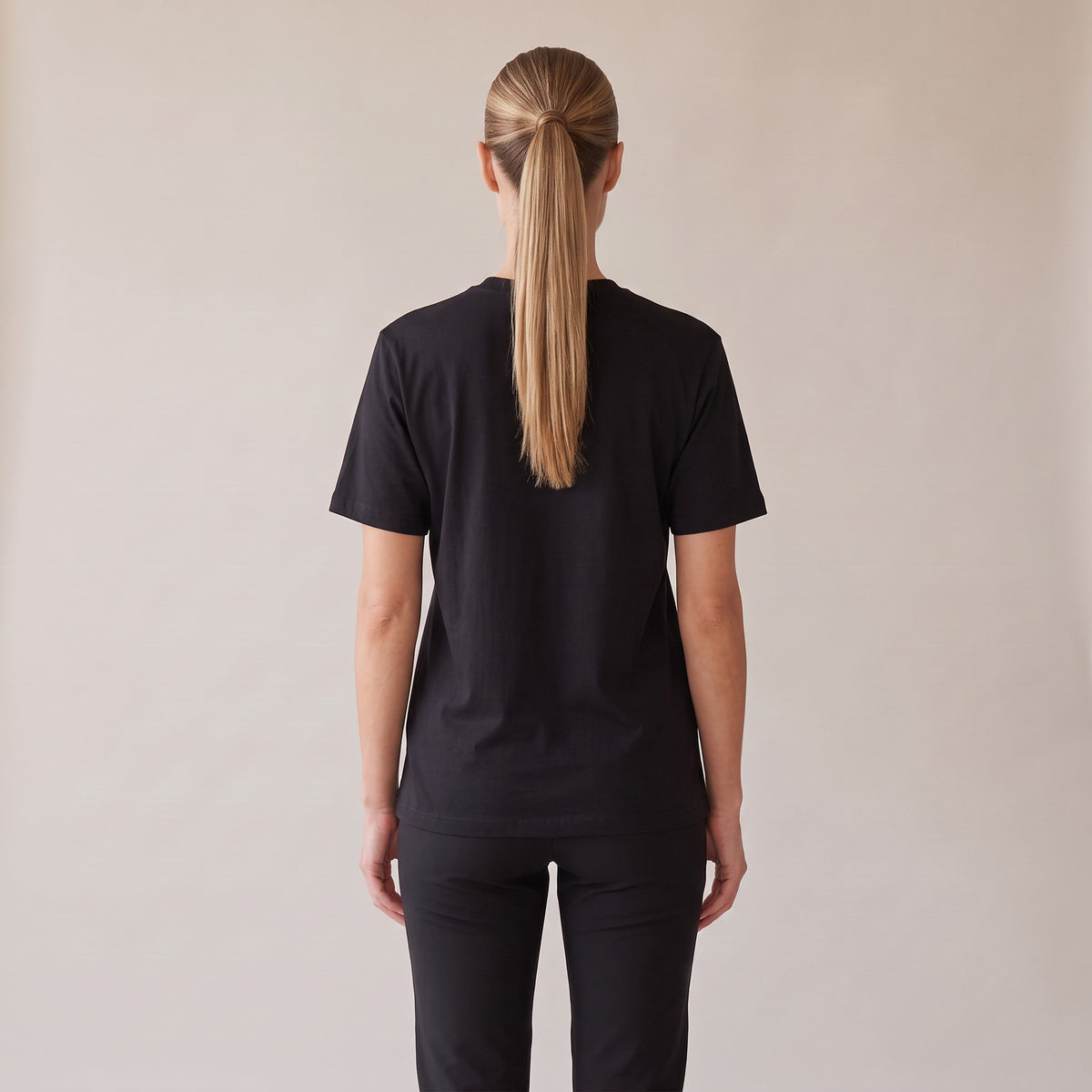 Sovereign Heavyweight Tee — AWSM Aurum in Onyx Black, back view on the AWSM house model
