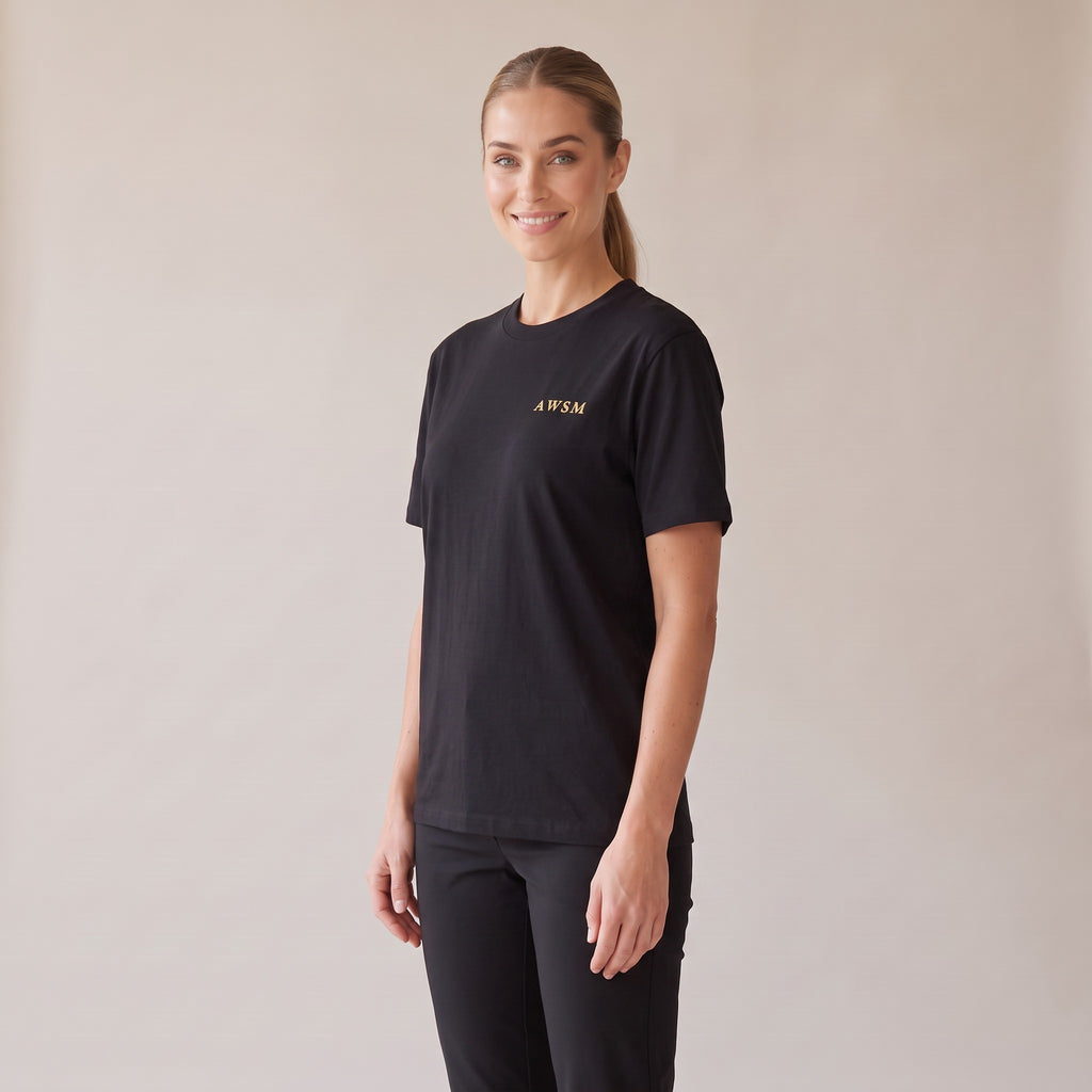 Sovereign Heavyweight Tee — AWSM Aurum in Onyx Black, three-quarter view on the AWSM house model
