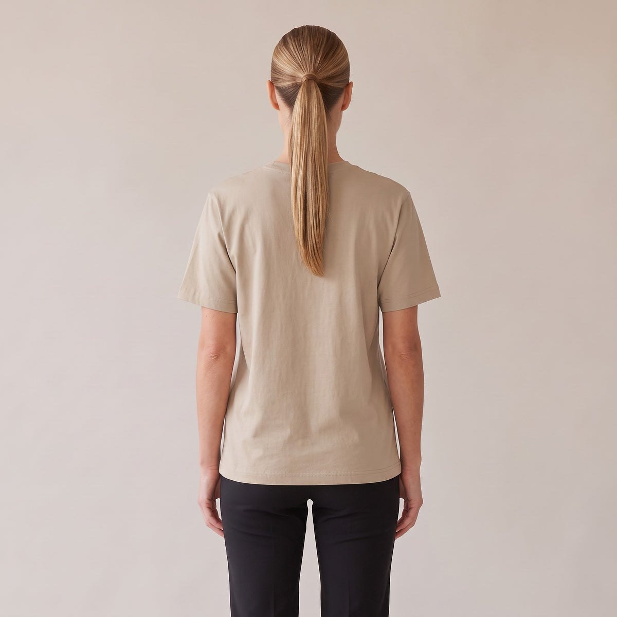 Terre Organic Tee — AWSM Atelier in Desert Dust, back view on the AWSM house model