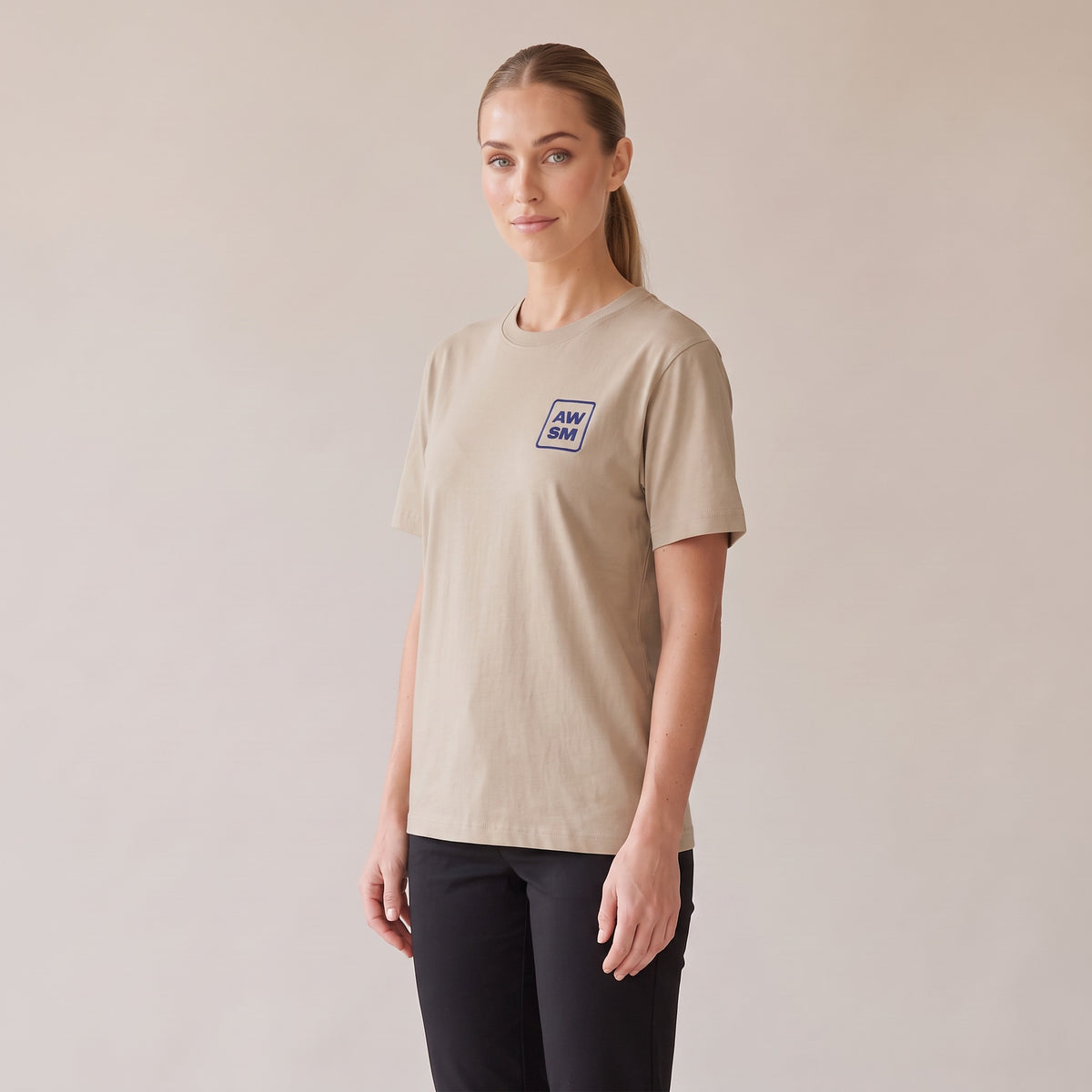 Terre Organic Tee — AWSM Atelier in Desert Dust, three-quarter view on the AWSM house model