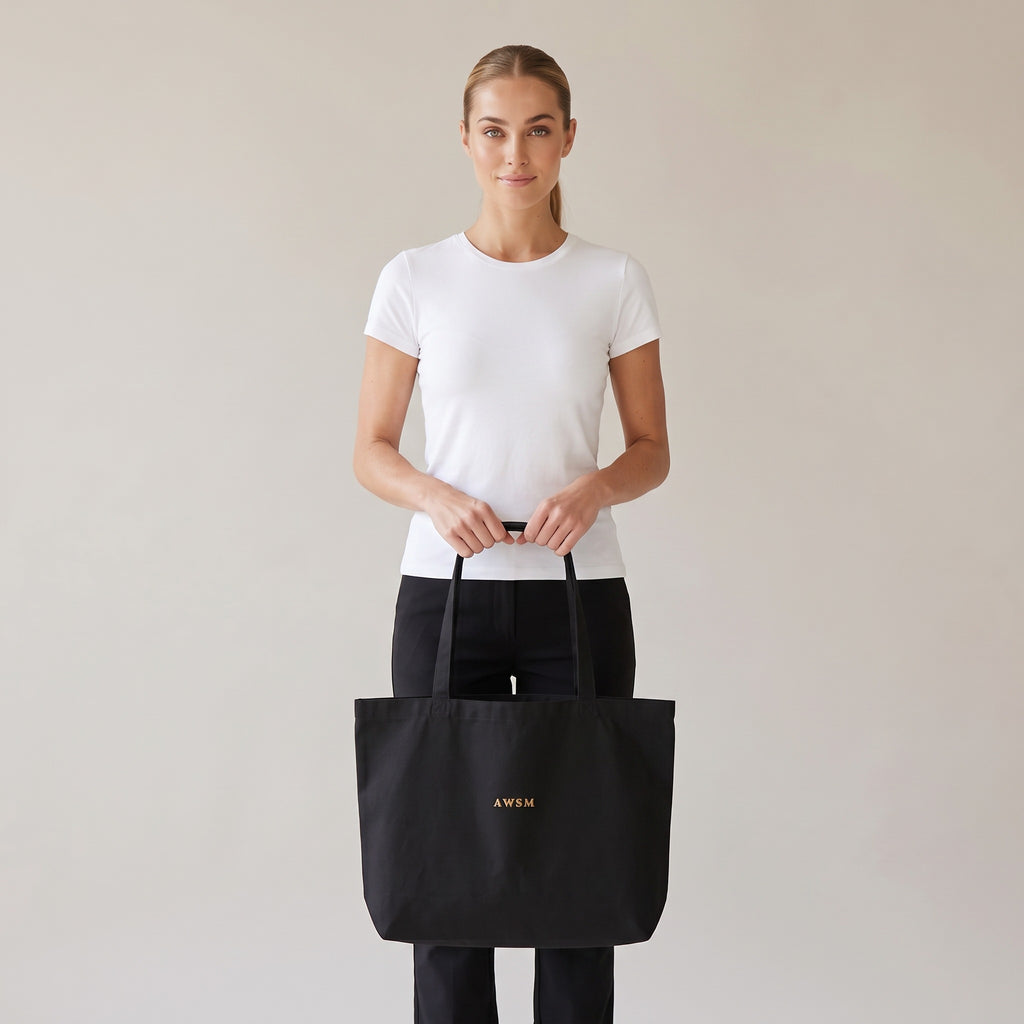 Trésor Twill Tote — AWSM Aurum in Onyx Black, shown on the AWSM house model