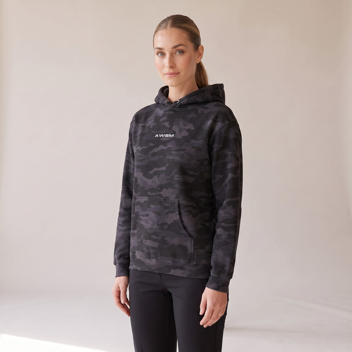Vanguard Heavyweight Hoodie — AWSM Field in Night Camo, three-quarter view on the AWSM house model