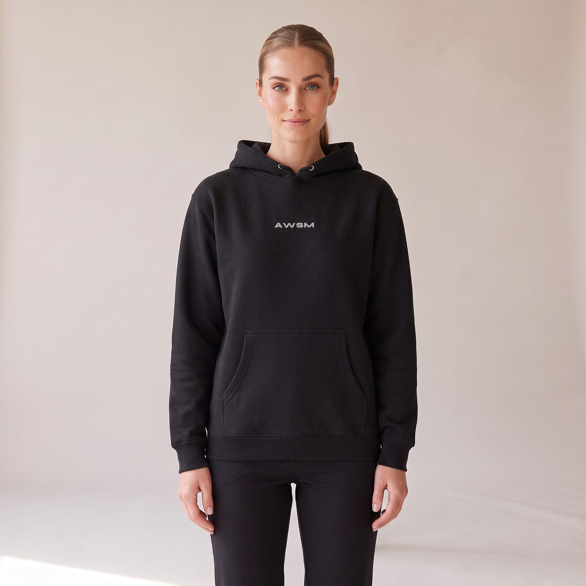 Vanguard Heavyweight Hoodie — AWSM Field in Onyx Black, front view on the AWSM house model
