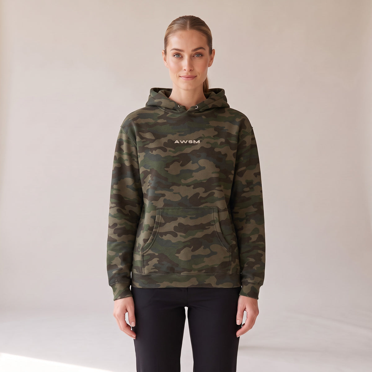 Vanguard Heavyweight Hoodie — AWSM Field in Woodland Camo, front view on the AWSM house model